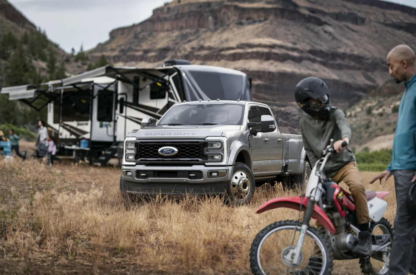 A silver 2023Ford F-350 Super Duty sits at a campsite after hauling a fifth wheel there.