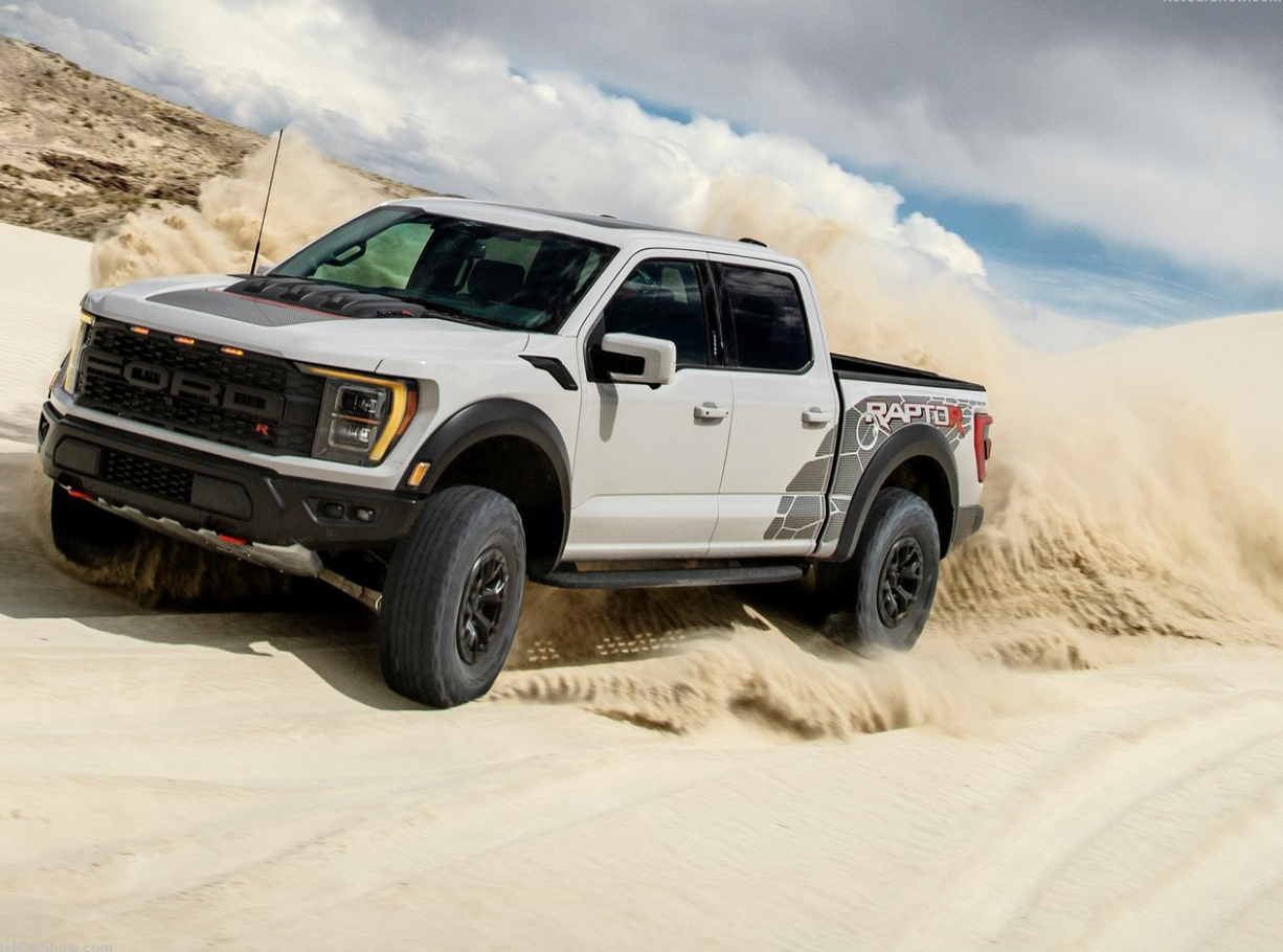 A profile view of a 2023 Ford F-150 Raptor-R in white with special side panel graphics