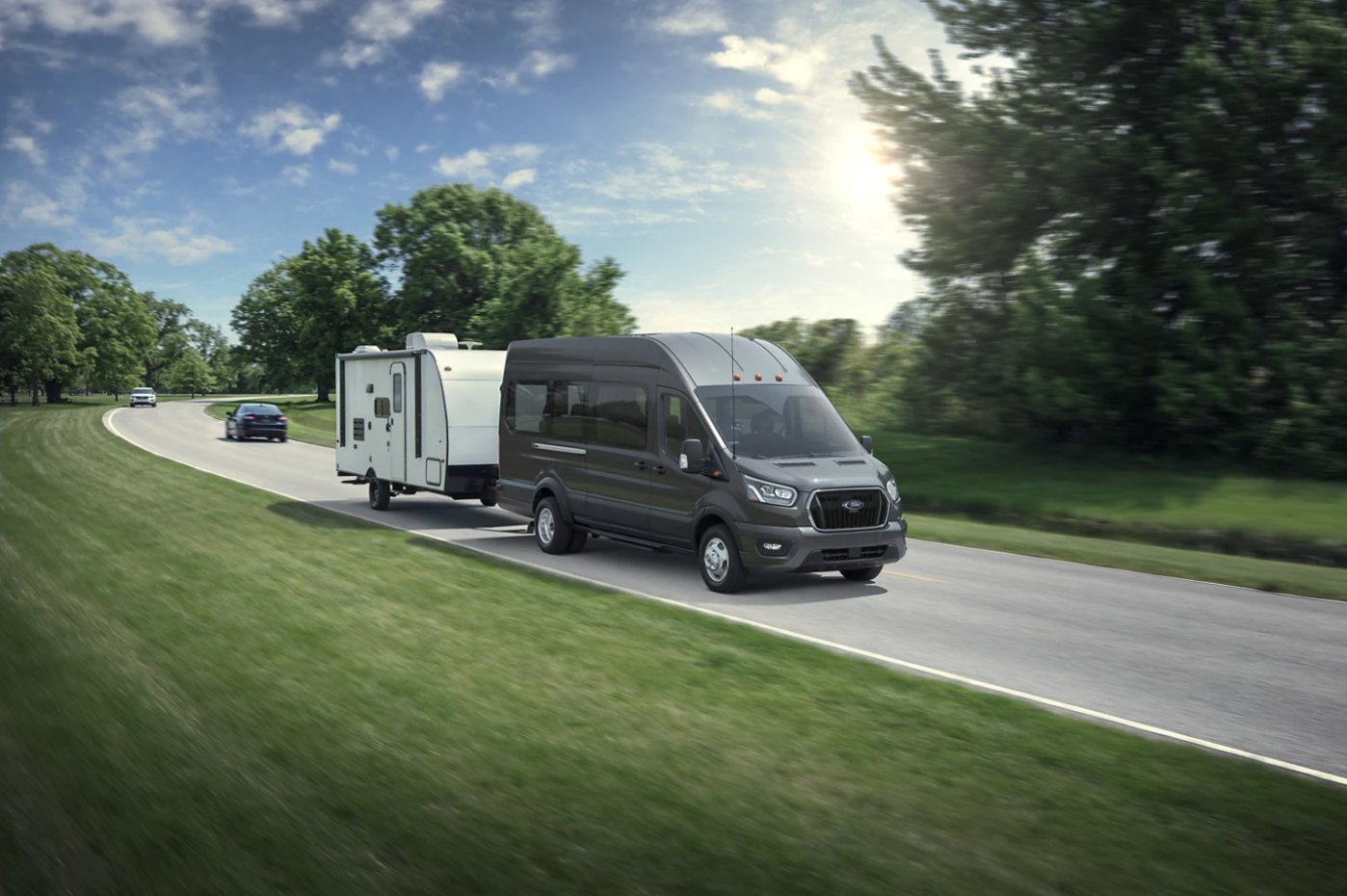 A 2023 E-Series hauls a camper down a country highway