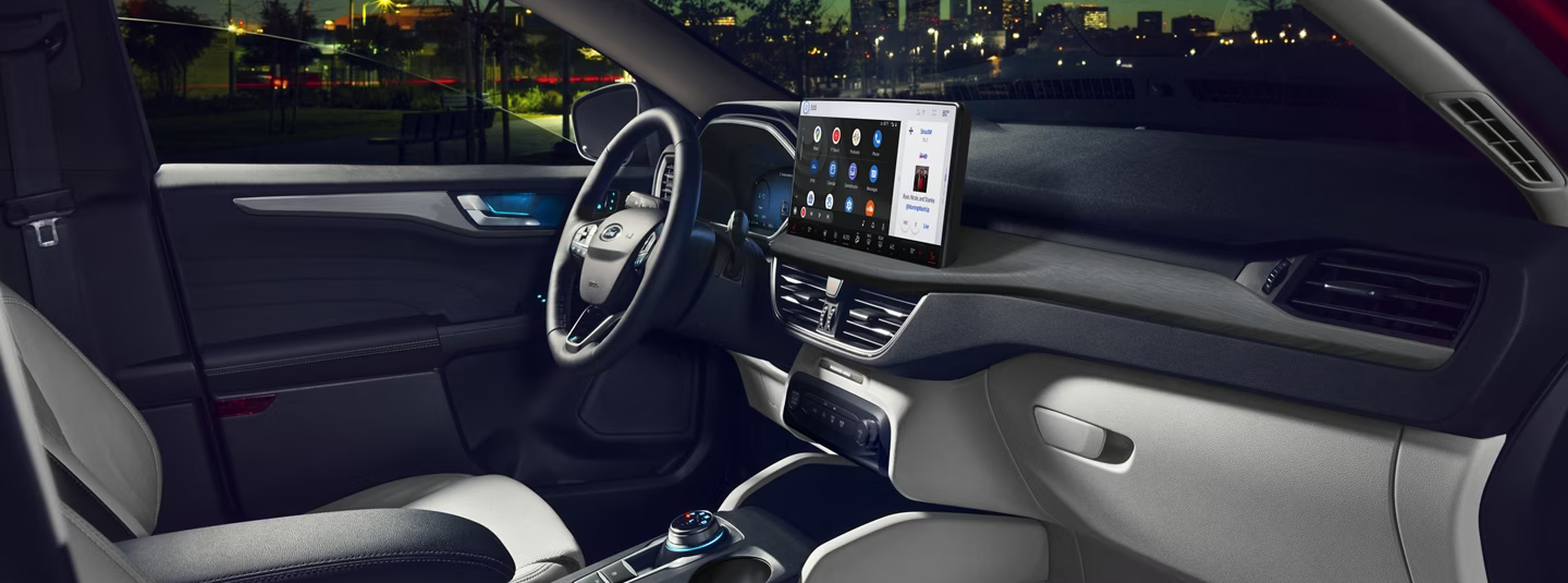 A red 2026 Ford Escape driving on a road