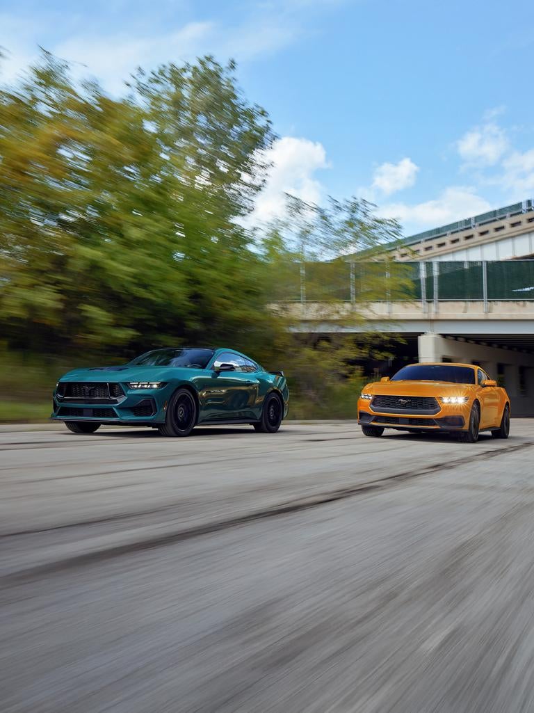 Two 2026 Ford Mustangs racing on a track