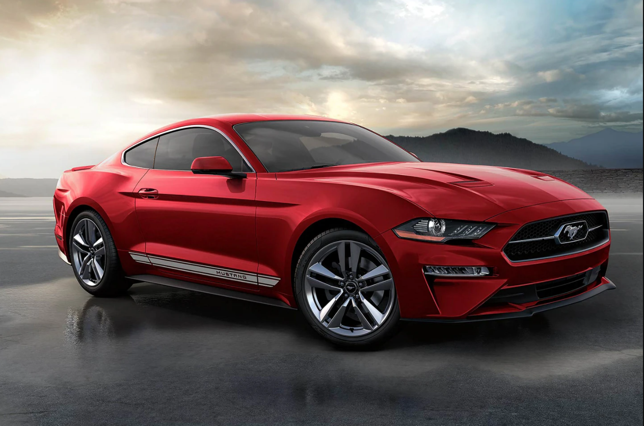 A red 2023 Ford Mustang in the middle of land